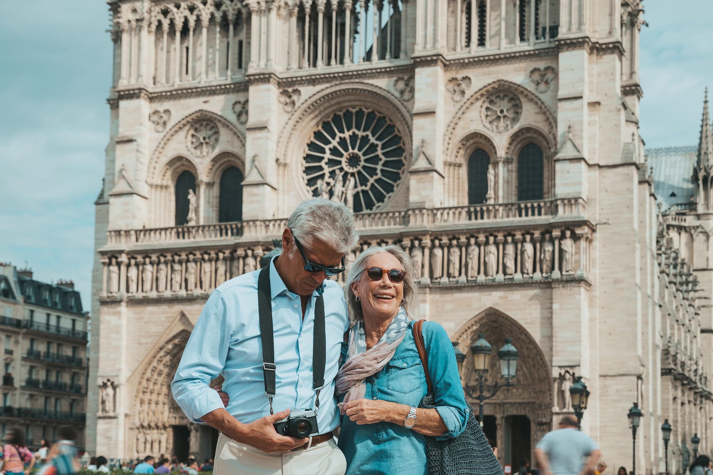 Couple sightseeing in front of Notre-Dame Cathedral in Paris